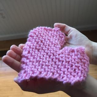 Knitted heart in child's hands