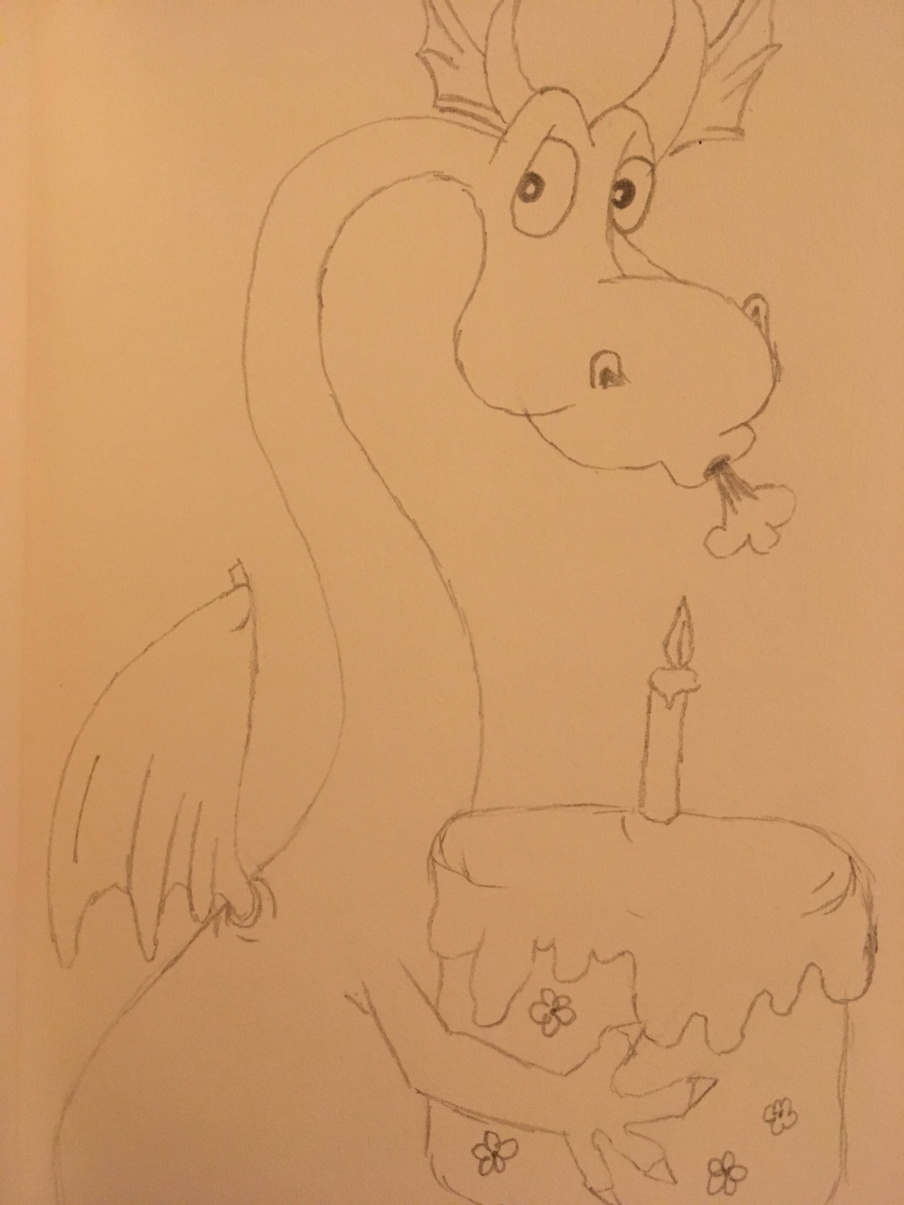 Sweet dragon blowing out candles on cake