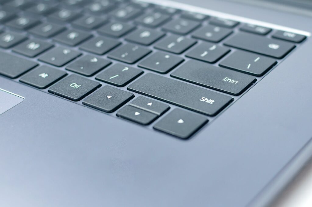 sentence fragments - modern laptop keyboard with comma on keys